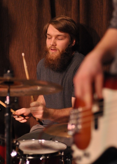 Steve Dahl meditating behind the drum kit.